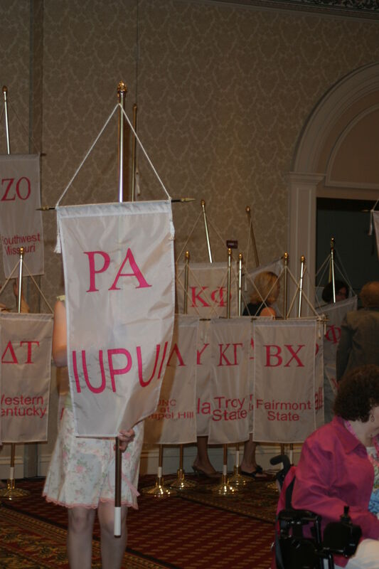 Unidentified Phi Mu With Rho Alpha Chapter Banner in Convention Parade of Flags Photograph, July 9, 2004 (Image)