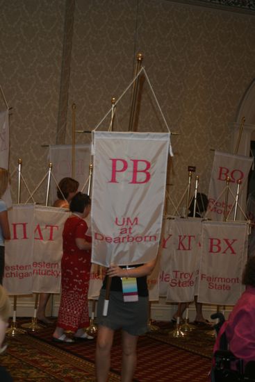 Unidentified Phi Mu With Rho Beta Chapter Banner in Convention Parade of Flags Photograph, July 9, 2004 (image)