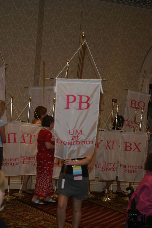 Unidentified Phi Mu With Rho Beta Chapter Banner in Convention Parade of Flags Photograph, July 9, 2004 (Image)
