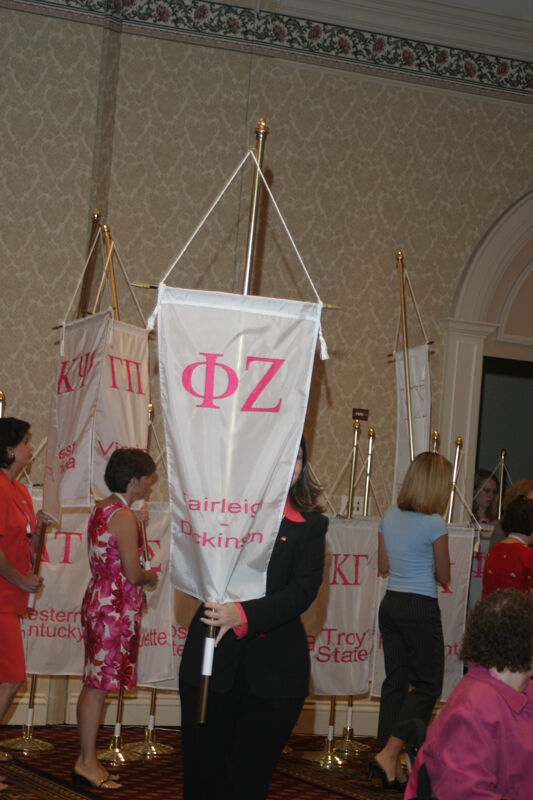 Unidentified Phi Mu With Phi Zeta Chapter Banner in Convention Parade of Flags Photograph, July 9, 2004 (Image)