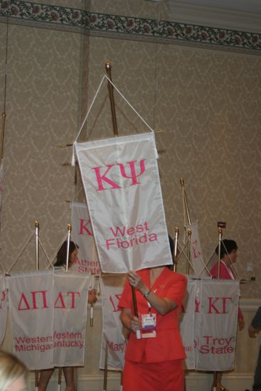 Ashley McDaniel With Kappa Psi Chapter Banner in Convention Parade of Flags Photograph, July 9, 2004 (image)