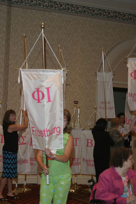 Unidentified Phi Mu With Phi Iota Chapter Banner in Convention Parade of Flags Photograph, July 9, 2004 (Image)