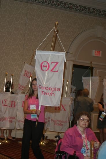 Unidentified Phi Mu With Theta Zeta Chapter Banner in Convention Parade of Flags Photograph, July 9, 2004 (image)