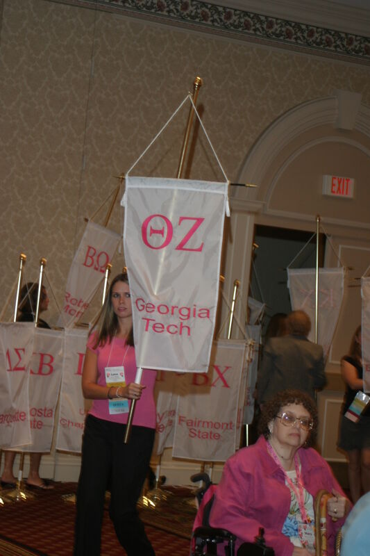 Unidentified Phi Mu With Theta Zeta Chapter Banner in Convention Parade of Flags Photograph, July 9, 2004 (Image)