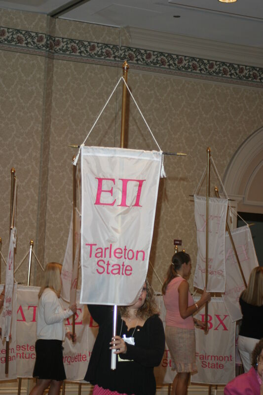 Unidentified Phi Mu With Epsilon Pi Chapter Banner in Convention Parade of Flags Photograph, July 9, 2004 (Image)