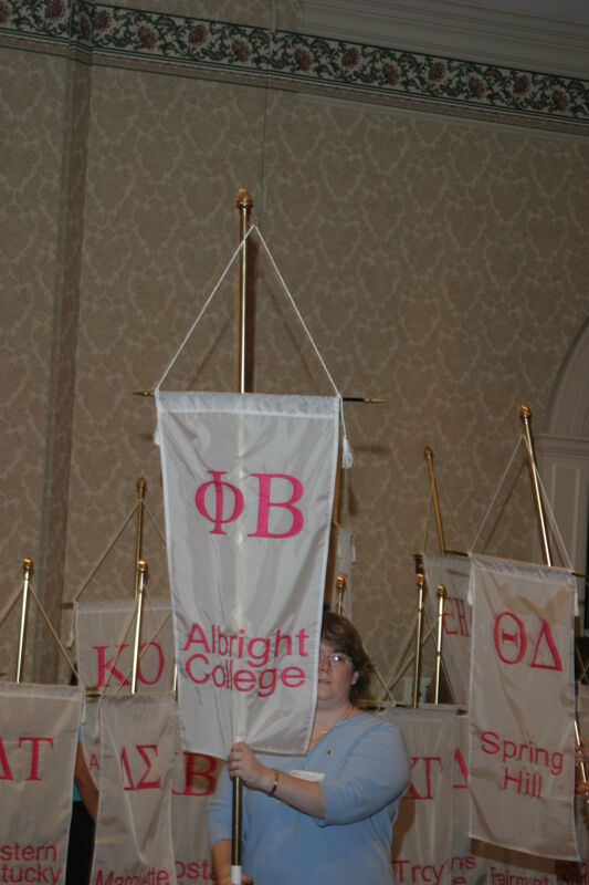 Unidentified Phi Mu With Phi Beta Chapter Banner in Convention Parade of Flags Photograph, July 9, 2004 (Image)