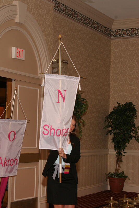 Unidentified Phi Mu With Nu Chapter Banner in Convention Parade of Flags Photograph, July 9, 2004 (Image)