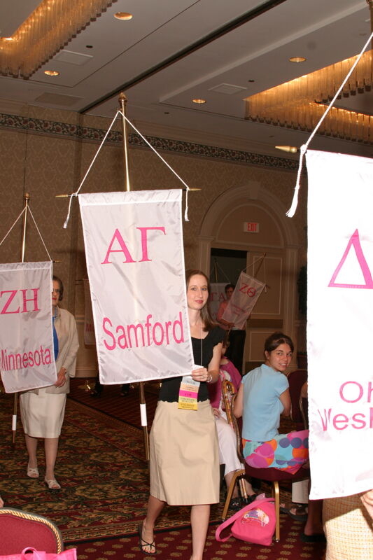 Unidentified Phi Mu With Alpha Gamma Chapter Banner in Convention Parade of Flags Photograph, July 9, 2004 (Image)