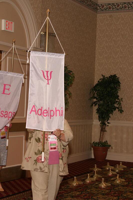 Margo Grace With Psi Chapter Banner in Convention Parade of Flags Photograph, July 9, 2004 (Image)