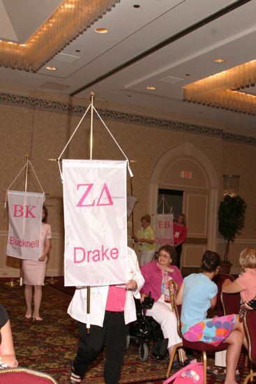 Unidentified Phi Mu With Zeta Delta Chapter Banner in Convention Parade of Flags Photograph, July 9, 2004 (image)