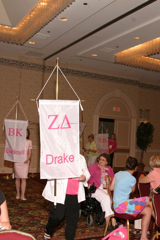 Unidentified Phi Mu With Zeta Delta Chapter Banner in Convention Parade of Flags Photograph, July 9, 2004 (Image)