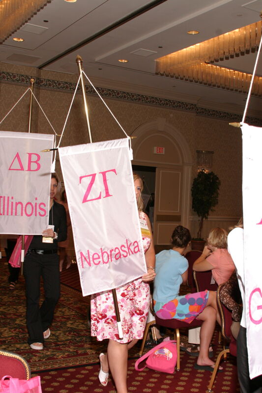 Unidentified Phi Mu With Zeta Gamma Chapter Banner in Convention Parade of Flags Photograph, July 9, 2004 (Image)