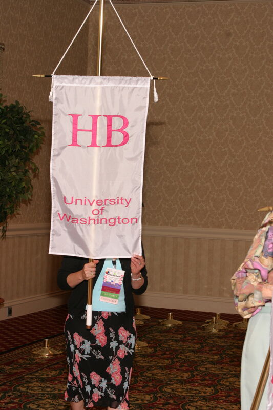 Gretchen Johnson With Eta Beta Chapter Banner in Convention Parade of Flags Photograph, July 9, 2004 (Image)