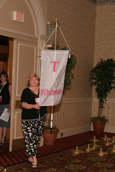 Debbie Noone With Tau Chapter Banner in Convention Parade of Flags Photograph, July 9, 2004 (image)