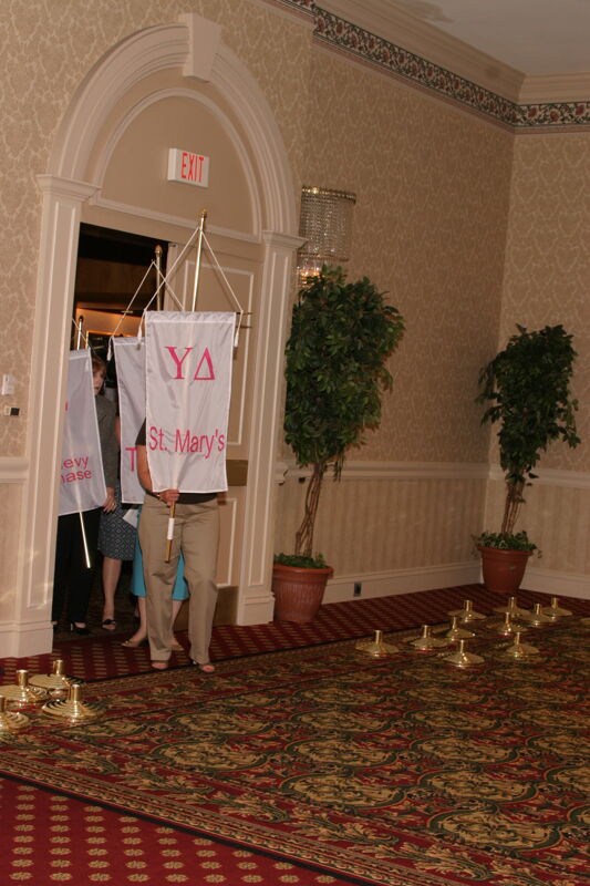 Unidentified Phi Mu With Upsilon Delta Chapter Banner in Convention Parade of Flags Photograph, July 9, 2004 (Image)