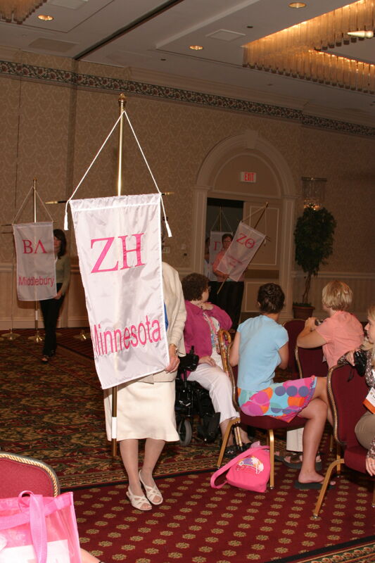 Unidentified Phi Mu With Zeta Eta Chapter Banner in Convention Parade of Flags Photograph, July 9, 2004 (Image)