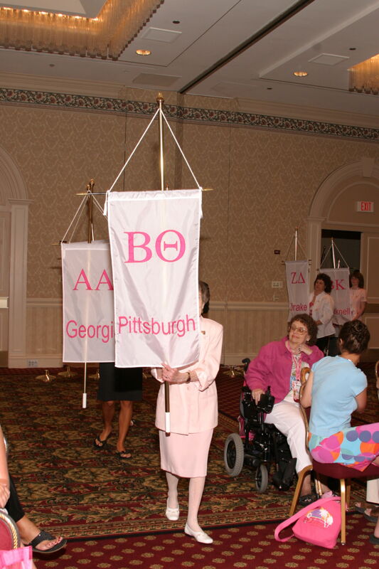 Unidentified Phi Mu With Beta Theta Chapter Banner in Convention Parade of Flags Photograph, July 9, 2004 (Image)