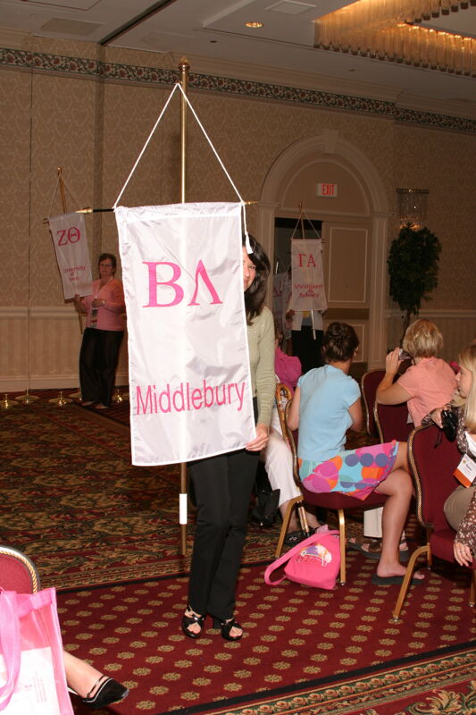 Unidentified Phi Mu With Beta Lambda Chapter Banner in Convention Parade of Flags Photograph, July 9, 2004 (Image)
