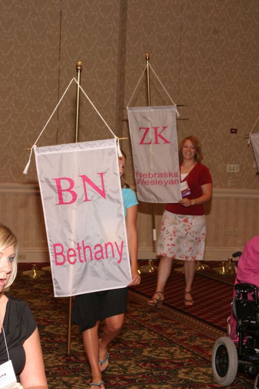 Unidentified Phi Mu With Beta Nu Chapter Banner in Convention Parade of Flags Photograph, July 9, 2004 (Image)