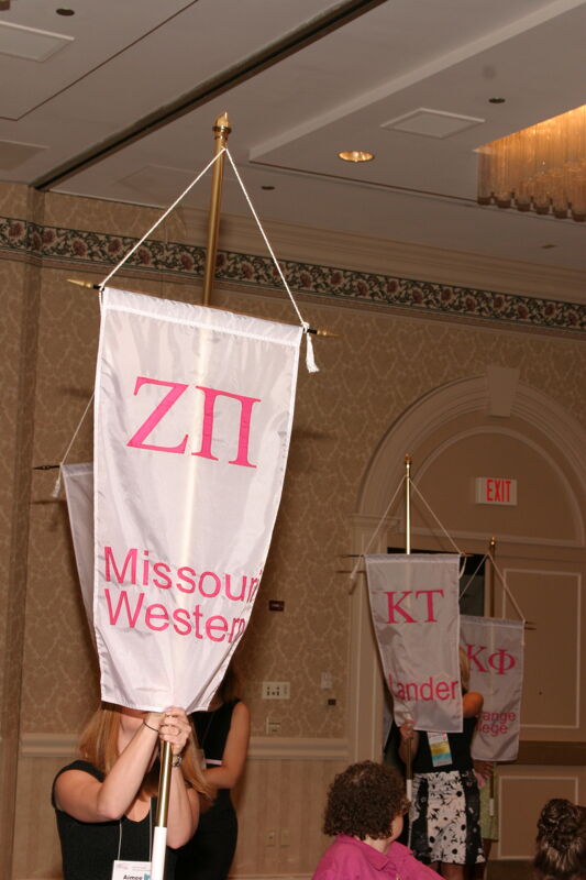 Unidentified Phi Mu With Zeta Pi Chapter Banner in Convention Parade of Flags Photograph, July 9, 2004 (Image)