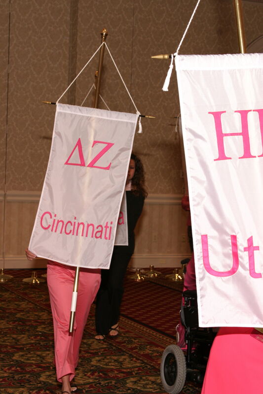 Unidentified Phi Mu With Delta Zeta Chapter Banner in Convention Parade of Flags Photograph, July 9, 2004 (Image)
