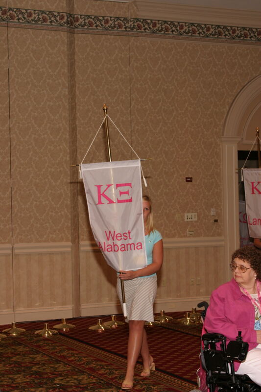 Unidentified Phi Mu With Kappa Xi Chapter Banner in Convention Parade of Flags Photograph, July 9, 2004 (Image)
