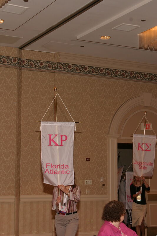 Unidentified Phi Mu With Kappa Rho Chapter Banner in Convention Parade of Flags Photograph 1, July 9, 2004 (Image)