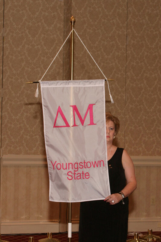 Unidentified Phi Mu With Delta Mu Chapter Banner in Convention Parade of Flags Photograph, July 9, 2004 (Image)