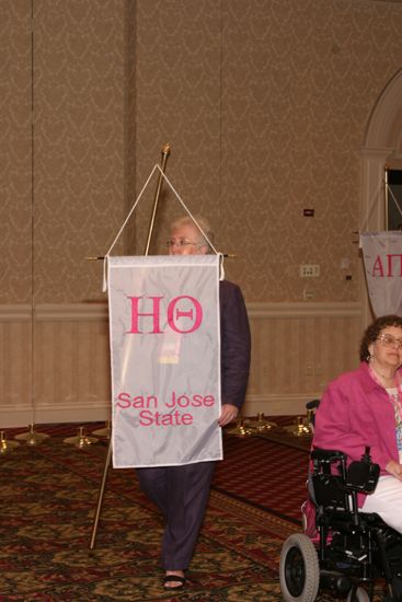 Claudia Nemir With Eta Theta Chapter Banner in Convention Parade of Flags Photograph, July 9, 2004 (image)