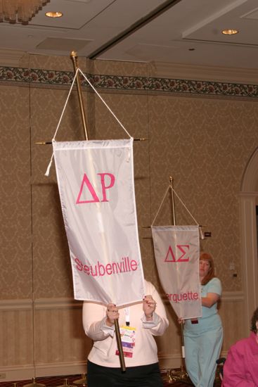 Gina Izer With Delta Rho Chapter Banner in Convention Parade of Flags Photograph, July 9, 2004 (image)