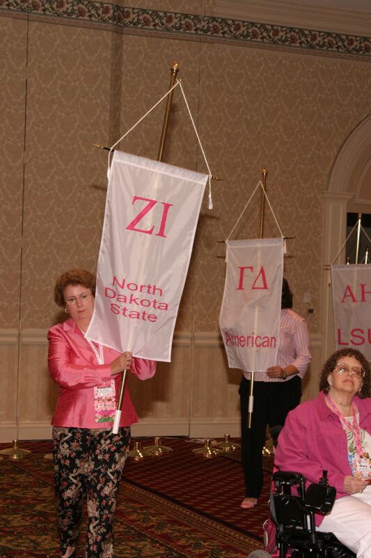 Unidentified Phi Mu With Zeta Iota Chapter Banner in Convention Parade of Flags Photograph, July 9, 2004 (Image)