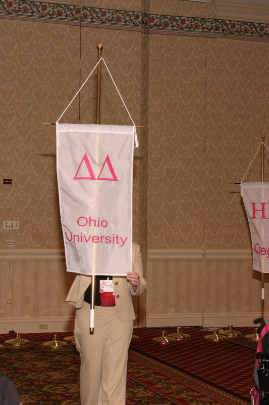 Ali Kearns With Delta Delta Chapter Banner in Convention Parade of Flags Photograph, July 9, 2004 (Image)