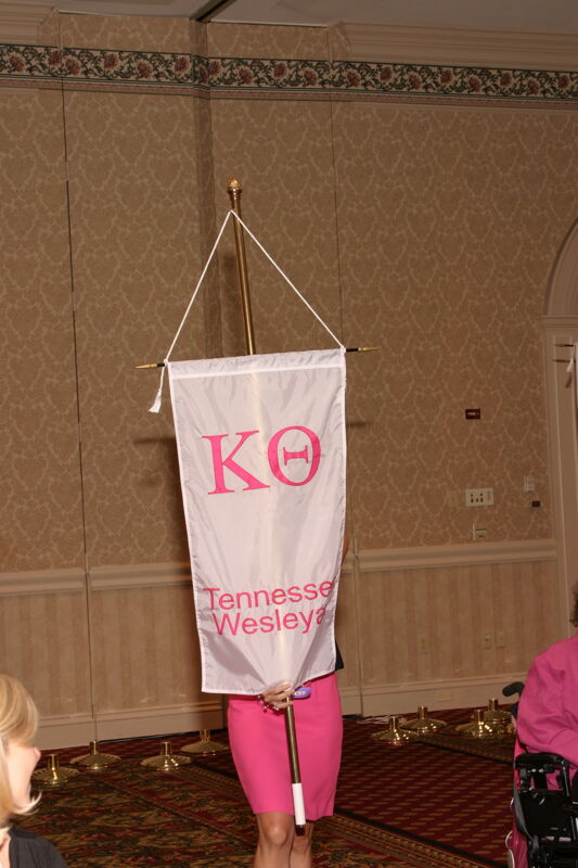 Unidentified Phi Mu With Kappa Theta Chapter Banner in Convention Parade of Flags Photograph, July 9, 2004 (Image)