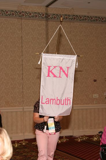 Jenny Williams With Kappa Nu Chapter Banner in Convention Parade of Flags Photograph, July 9, 2004 (image)