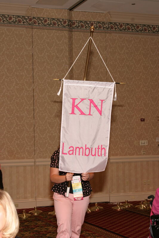 Jenny Williams With Kappa Nu Chapter Banner in Convention Parade of Flags Photograph, July 9, 2004 (Image)