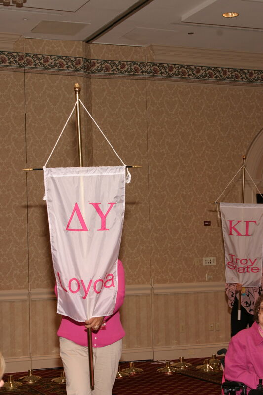 Unidentified Phi Mu With Delta Upsilon Chapter Banner in Convention Parade of Flags Photograph, July 9, 2004 (Image)