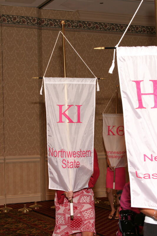 Unidentified Phi Mu With Kappa Iota Chapter Banner in Convention Parade of Flags Photograph, July 9, 2004 (Image)