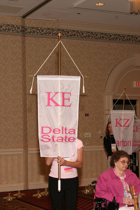 Unidentified Phi Mu With Kappa Epsilon Chapter Banner in Convention Parade of Flags Photograph, July 9, 2004 (Image)