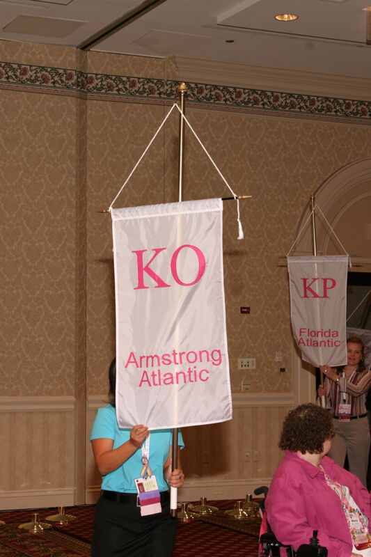 Unidentified Phi Mu With Kappa Omicron Chapter Banner in Convention Parade of Flags Photograph, July 9, 2004 (Image)
