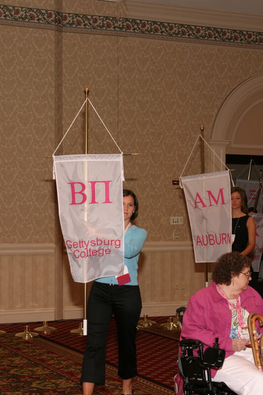 Unidentified Phi Mu With Beta Pi Chapter Banner in Convention Parade of Flags Photograph, July 9, 2004 (Image)