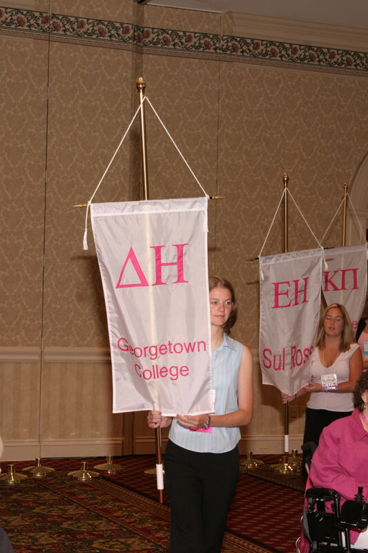 Unidentified Phi Mu With Delta Eta Chapter Banner in Convention Parade of Flags Photograph, July 9, 2004 (Image)
