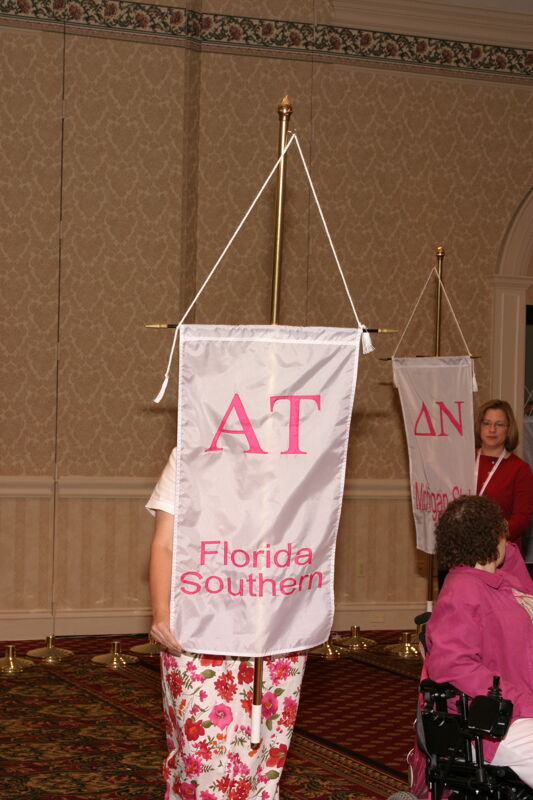 Unidentified Phi Mu With Alpha Tau Chapter Banner in Convention Parade of Flags Photograph, July 9, 2004 (Image)