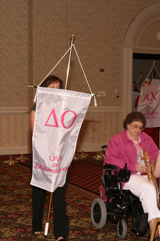 Unidentified Phi Mu With Delta Omicron Chapter Banner in Convention Parade of Flags Photograph, July 9, 2004 (Image)
