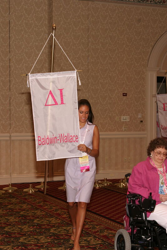 Unidentified Phi Mu With Delta Iota Chapter Banner in Convention Parade of Flags Photograph, July 9, 2004 (Image)