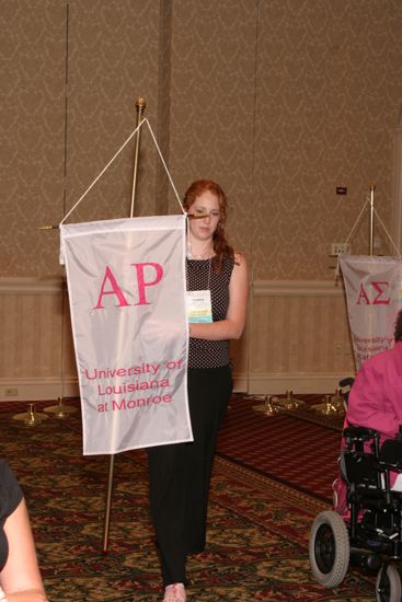 Unidentified Phi Mu With Alpha Rho Chapter Banner in Convention Parade of Flags Photograph, July 9, 2004 (image)