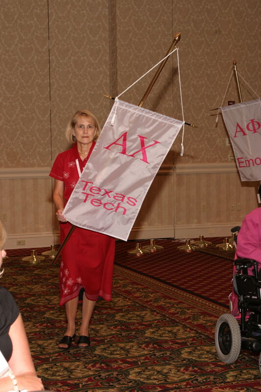 Donna Stallard With Alpha Chi Chapter Banner in Convention Parade of Flags Photograph, July 9, 2004 (Image)
