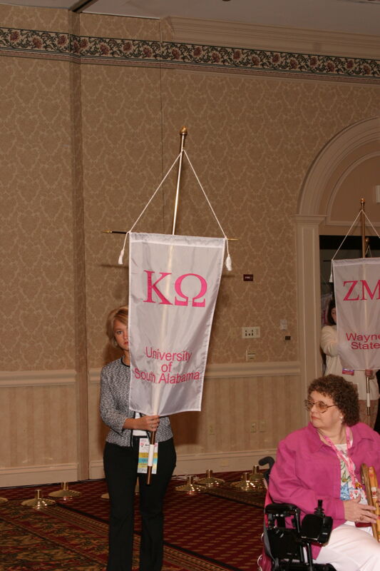 Unidentified Phi Mu With Kappa Omega Chapter Banner in Convention Parade of Flags Photograph, July 9, 2004 (Image)