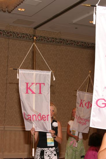 Unidentified Phi Mu With Kappa Tau Chapter Banner in Convention Parade of Flags Photograph, July 9, 2004 (image)