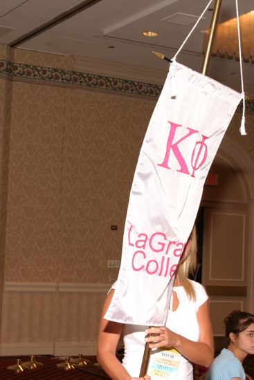 Unidentified Phi Mu With Kappa Phi Chapter Banner in Convention Parade of Flags Photograph, July 9, 2004 (image)