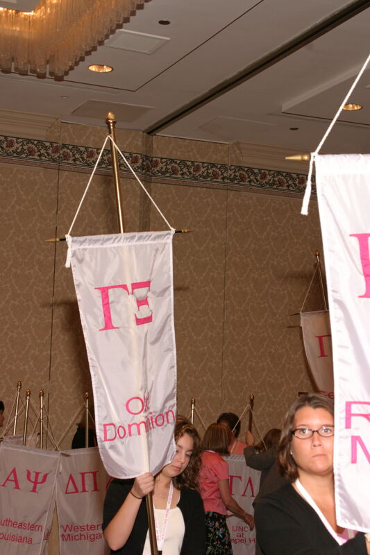 Unidentified Phi Mu With Gamma Xi Chapter Banner in Convention Parade of Flags Photograph, July 9, 2004 (Image)